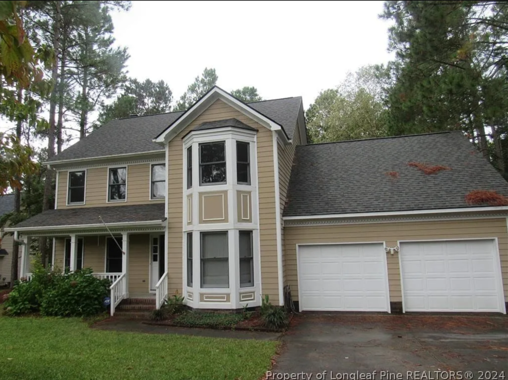 2-story home with beige siding. 2-car garage
